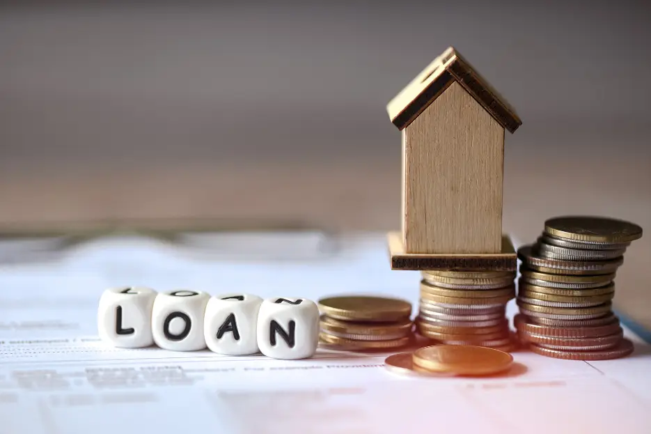 Model house and coins representing doctor home loan deposit and LMI options