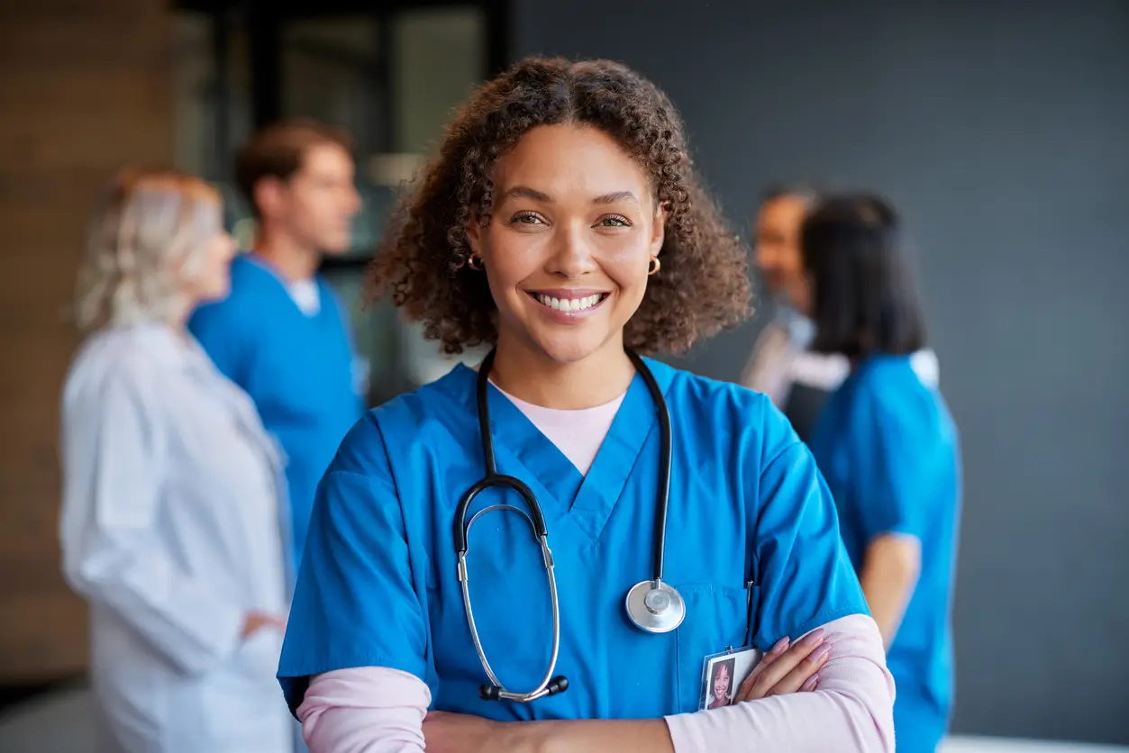 Doctor in scrubs with medical colleagues representing future home and property plans