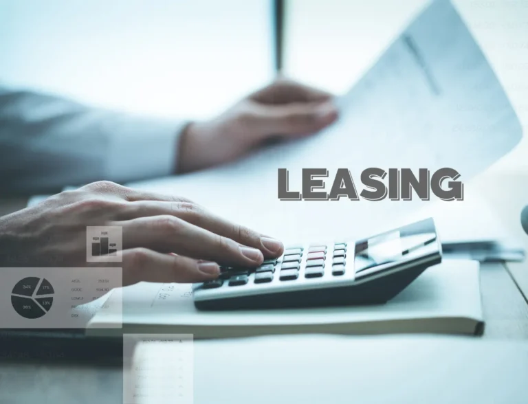 Business professional using calculator while reviewing lease documents – leasing calculator concept.