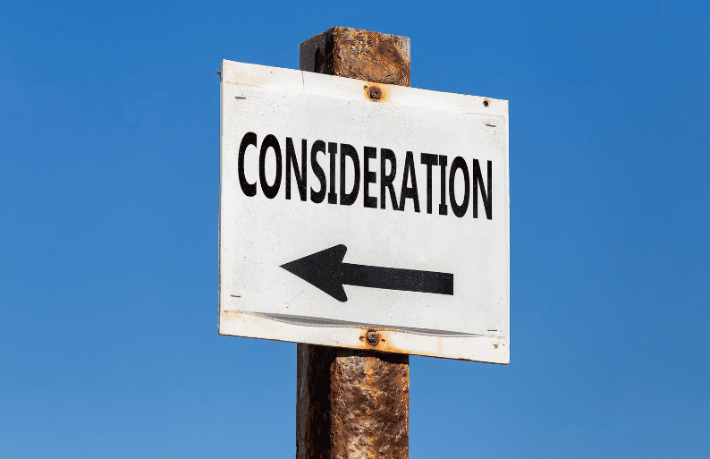 A weathered signpost with the word “CONSIDERATION” and a left-pointing arrow against a clear blue sky, symbolising important factors to think about before making a decision.