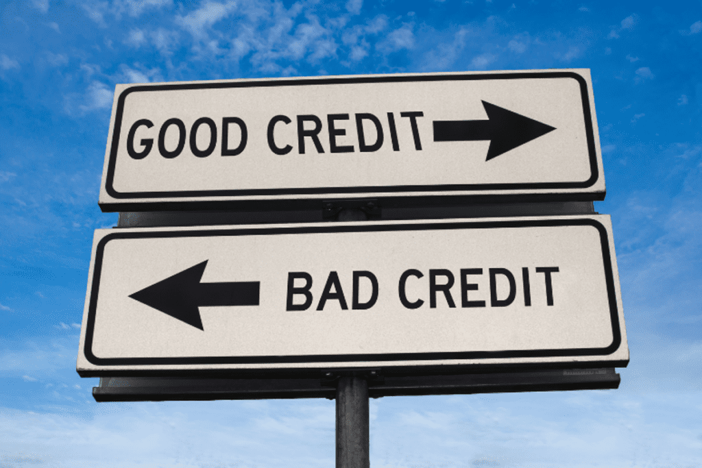 Directional road signs with arrows labeled "Good Credit" and "Bad Credit" against a blue sky.