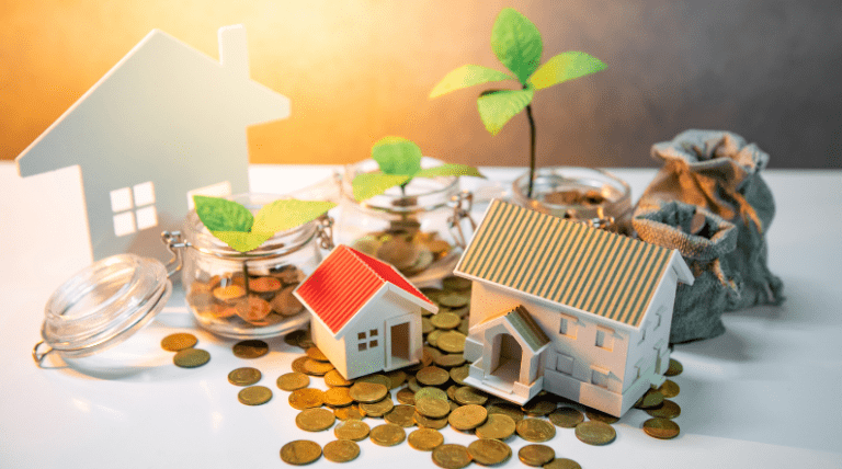 Miniature house models, coin jars with seedlings, and scattered gold coins symbolising the rentvesting strategy—renting to live and investing to grow wealth.