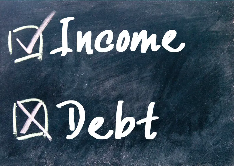 Chalkboard with checkmarks next to “Income” and a cross next to “Debt”, symbolising financial prioritisation.