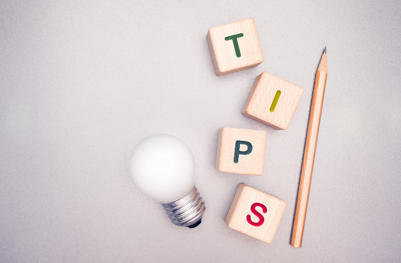 Wooden blocks spelling “TIPS” with bulb and pencil