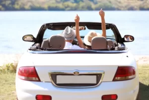 Couple in convertible celebrating car purchase