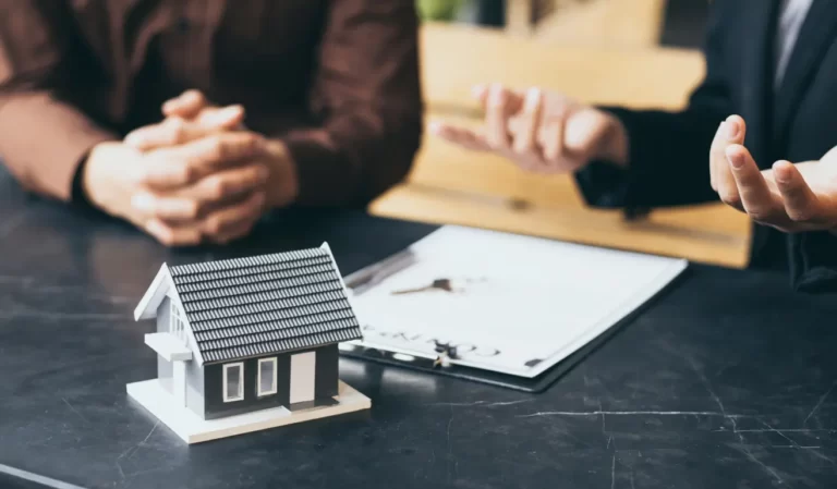 People discussing home loan with property model