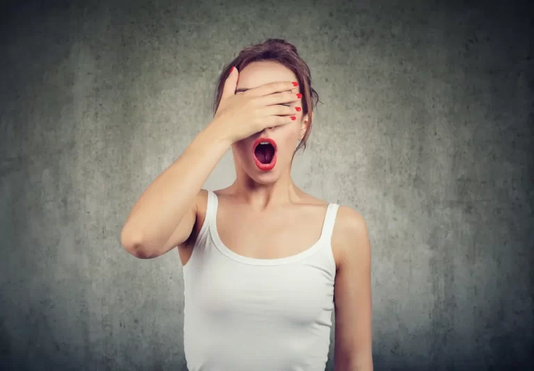 Surprised woman covering one eye with her hand, symbolising unexpected mistakes or misunderstandings.