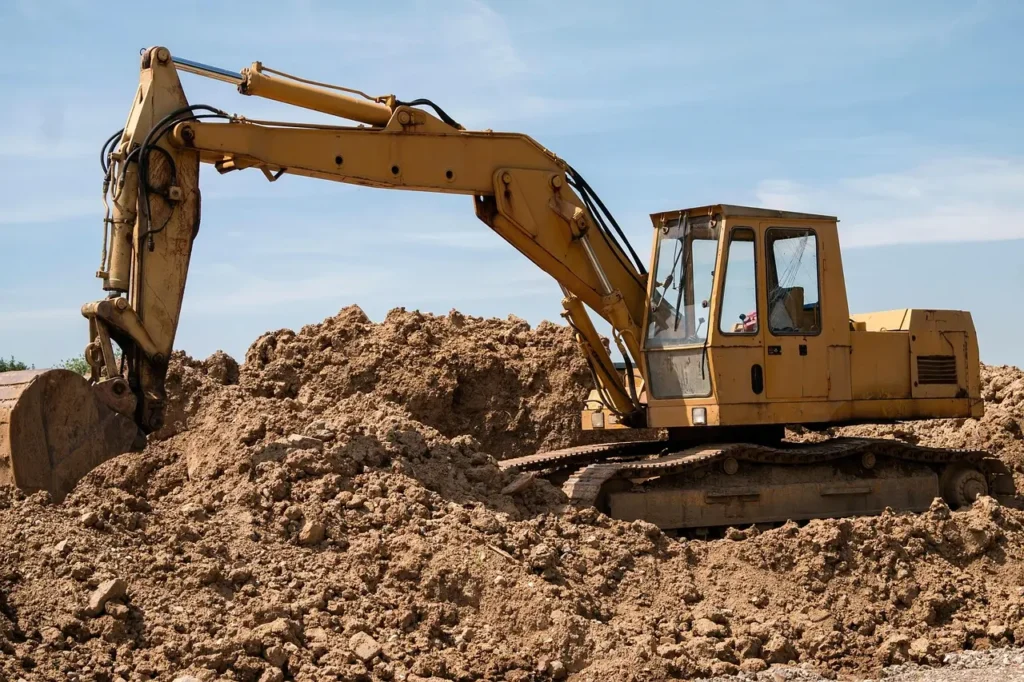 Excavator digging soil for new home construction loan project