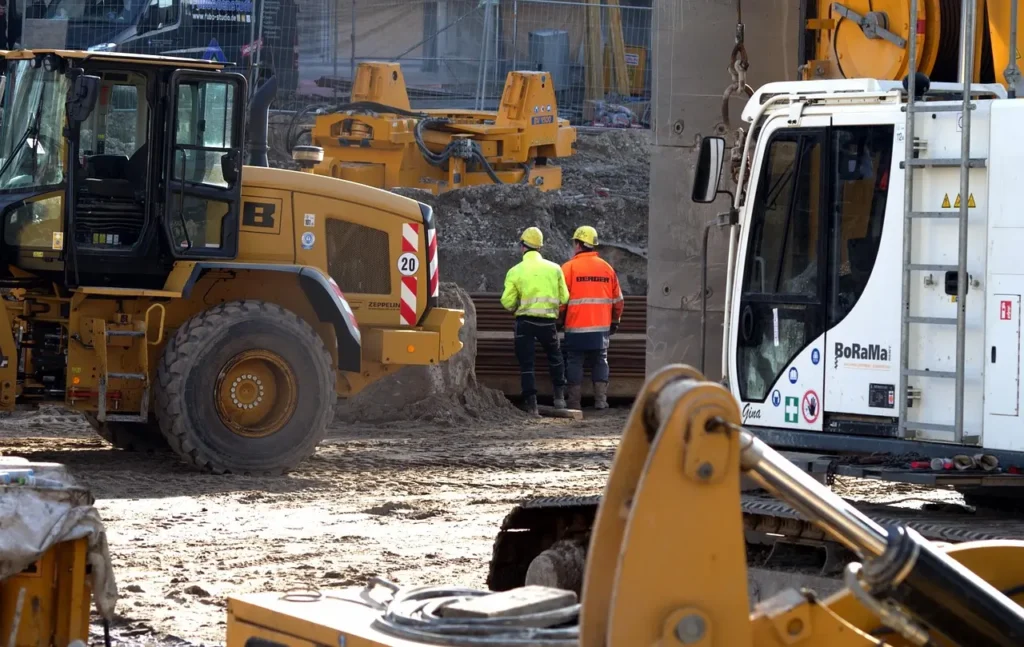 Construction workers on site discussing building loan project