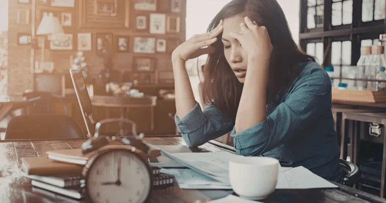 Stressed first home buyer reviewing finances after loan approval issues