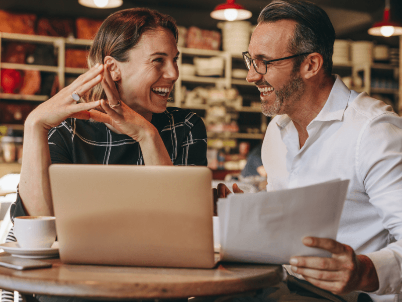 Self-employed couple reviewing financial documents and discussing home loan options
