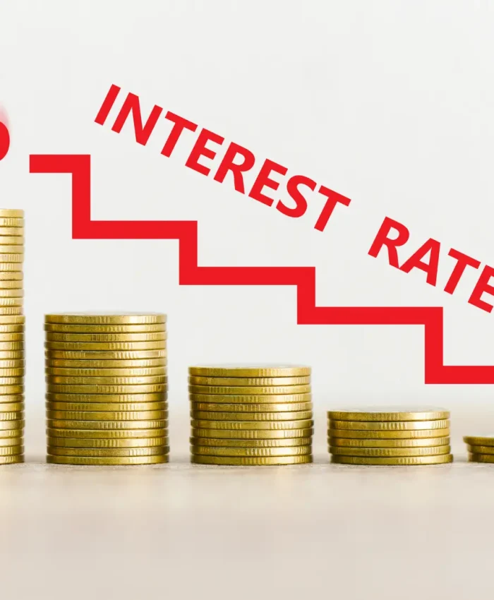 An illustration of stacked coins with a downward interest rate arrow, representing changes in interest-only loan repayments.