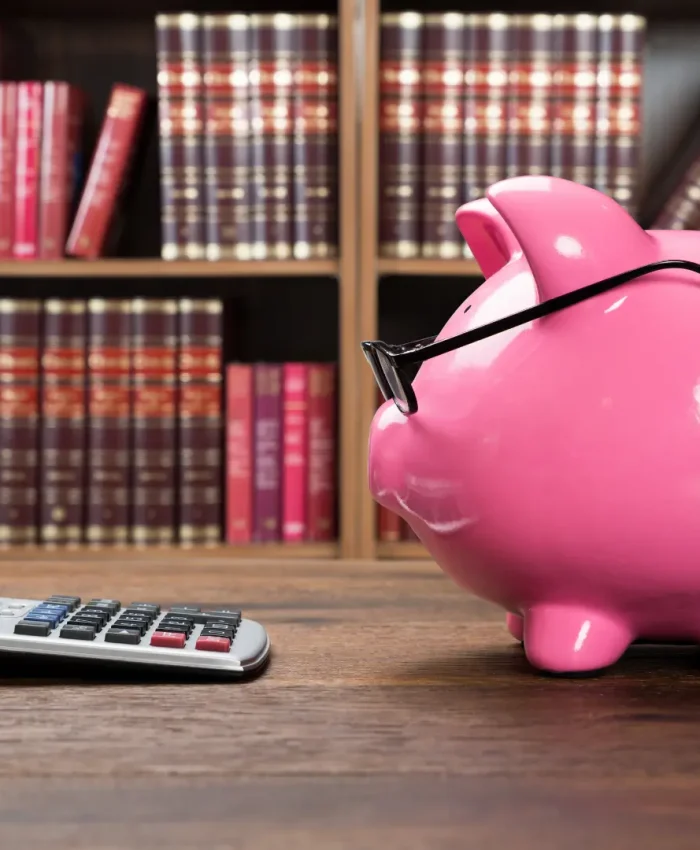 A piggy bank and calculator representing savings and loan planning.